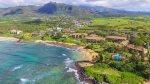 Drone view of the ocean front Lae Nani resort with a mountain background